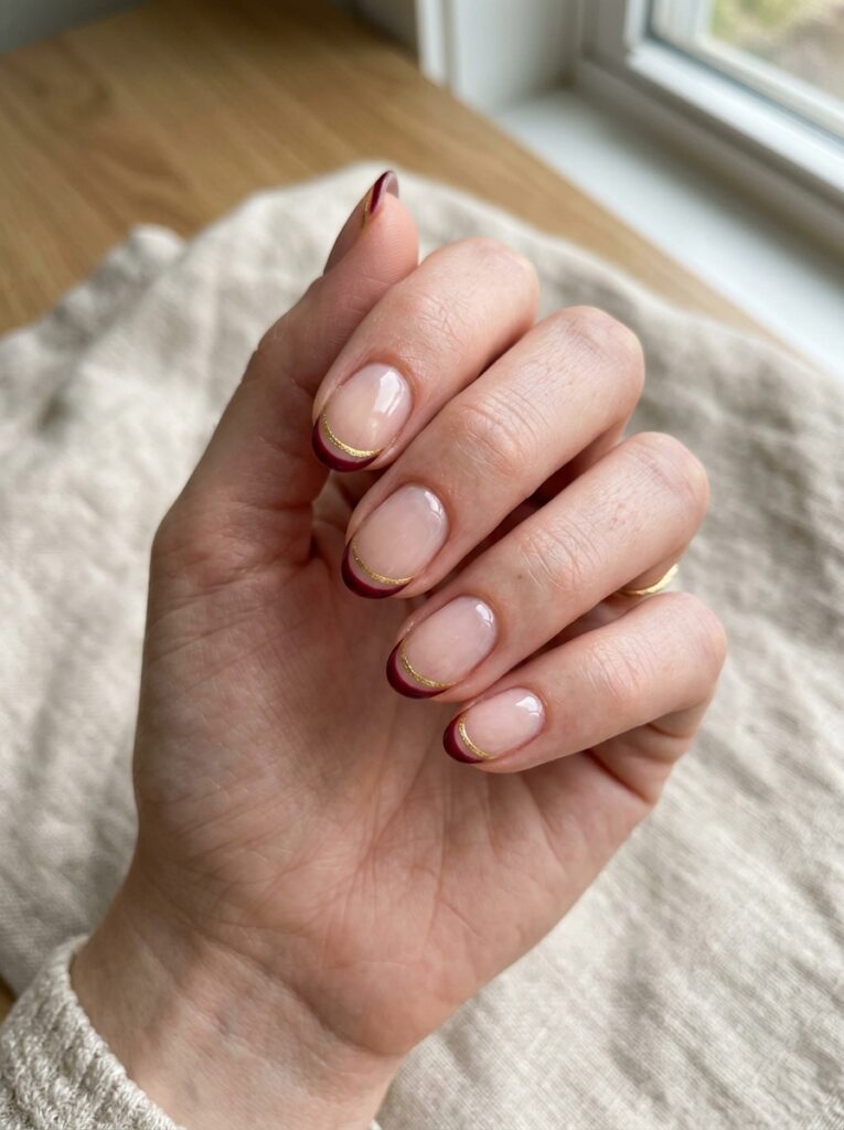 22 Burgundy Nail Ideas: How to Wear Fall's It Color double line burgundy and gold tip nails