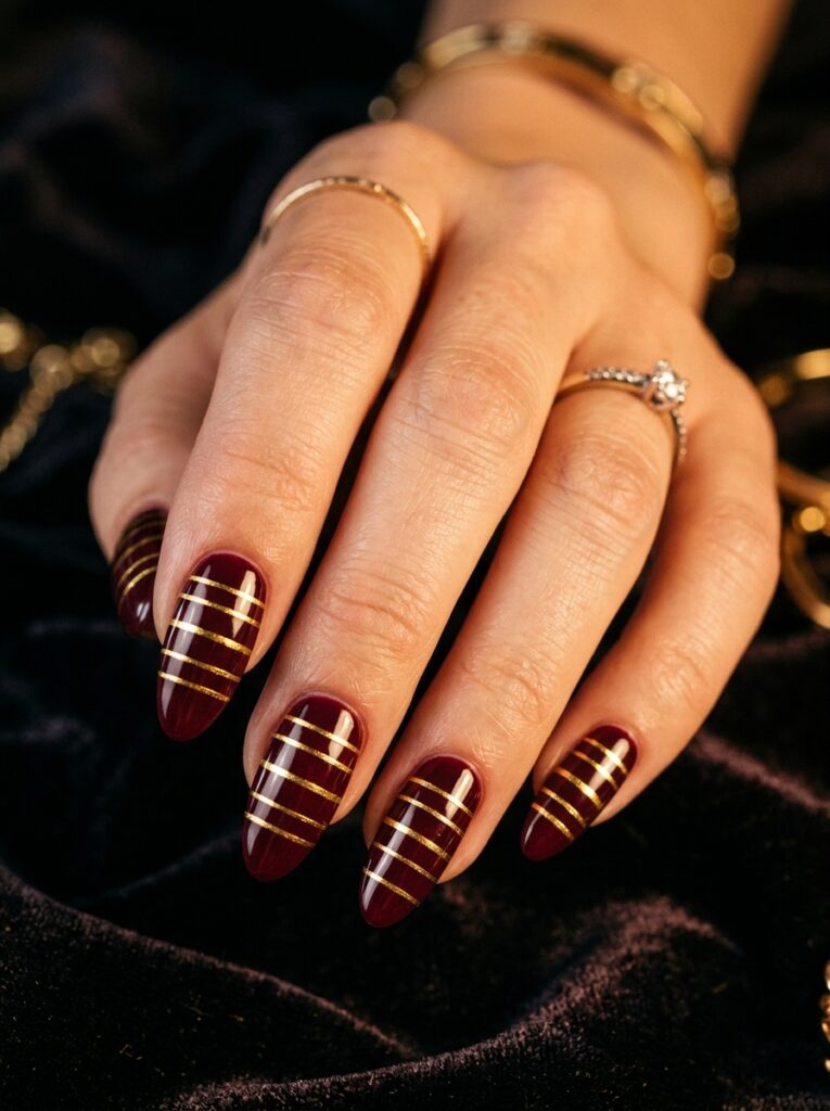 metallic gold stripes on burgundy nails