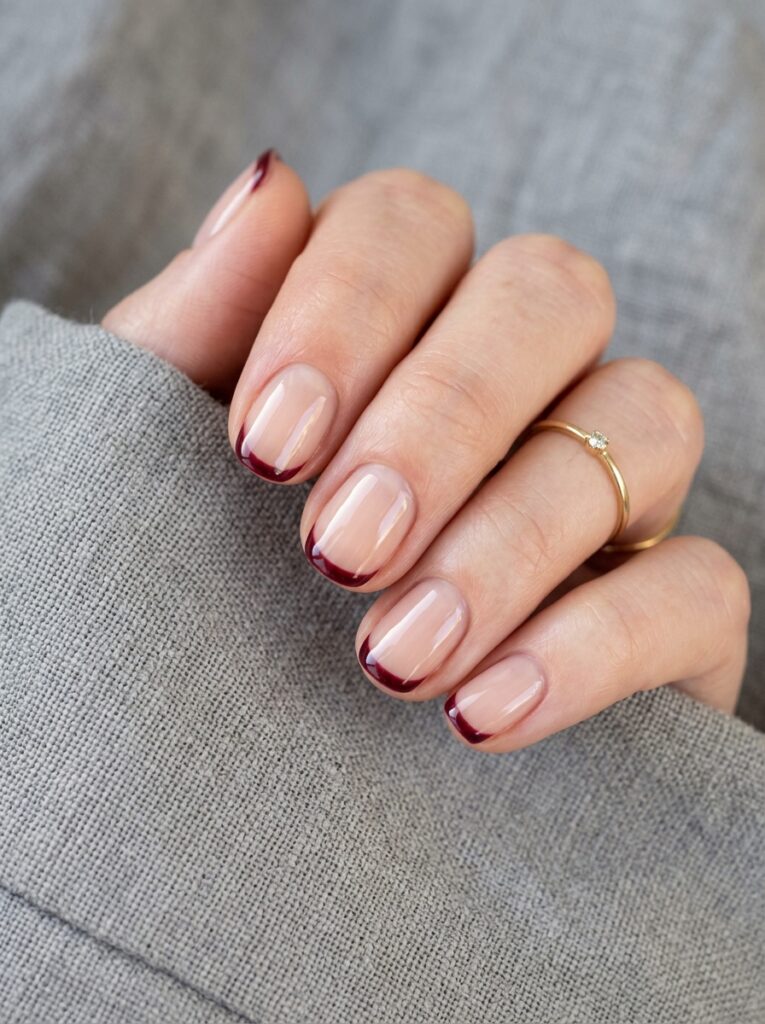 glossy garnet french tip nails