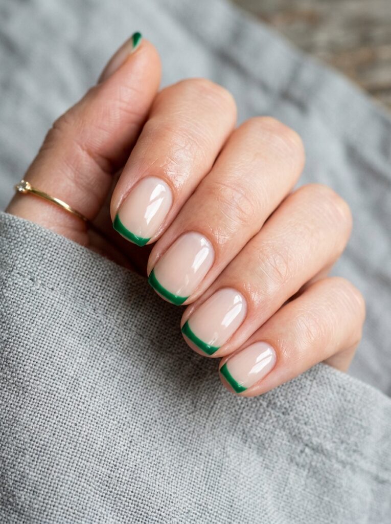 emerald french tips on milky nude nails