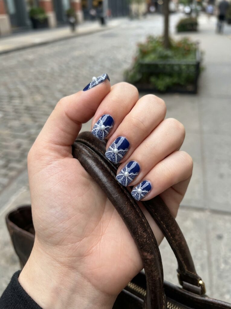navy lace nails with tiny pearl studs
