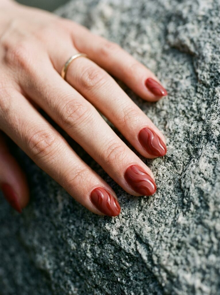 matte brick red nails with glossy waves