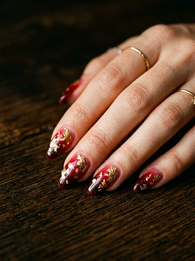 ruby red ombre nails with gold leaf