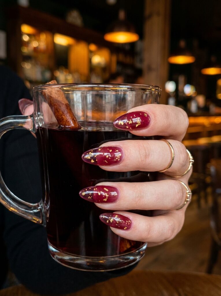 burgundy jelly nails with gold leaf flakes