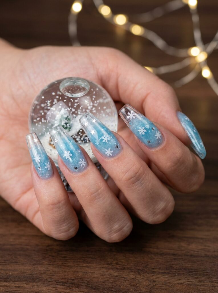 icy blue snow globe nails with snowflake glitter