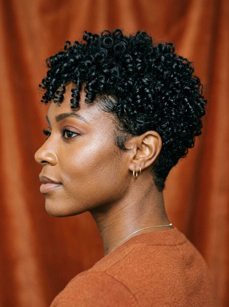 defined curly pixie cut with tapered nape