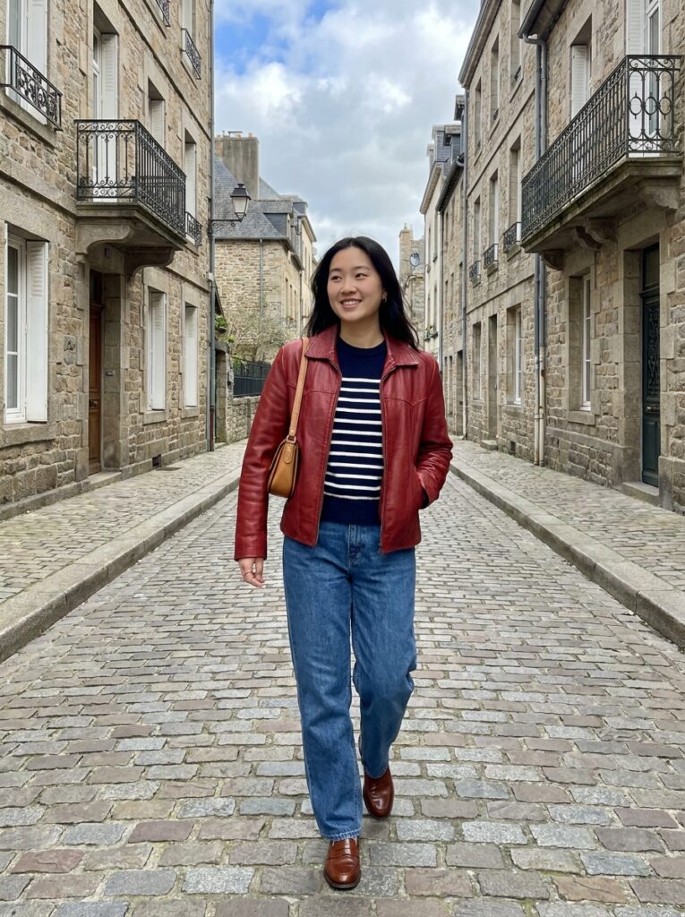 Red leather jacket with a striped sweater and blue jeans